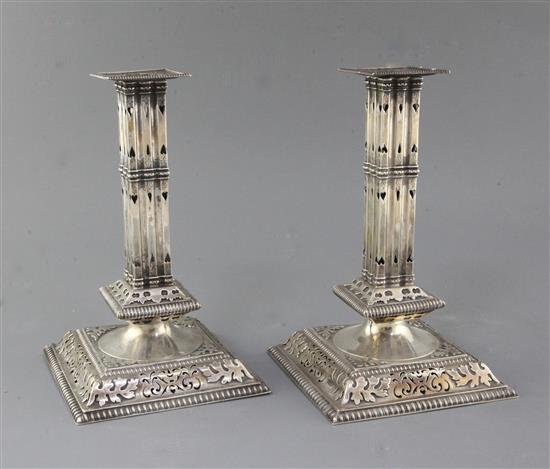 A pair of Victorian pierced silver square cluster column candlesticks by John Newton Mappin,